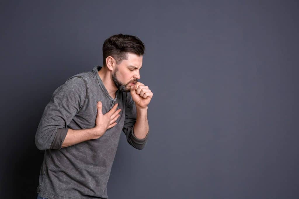 Man coughing with chest pain